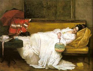 Girl in a white dress resting on a sofa