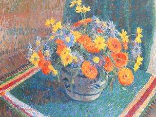 A still life of summer flowers in a pottery bowl on a table
