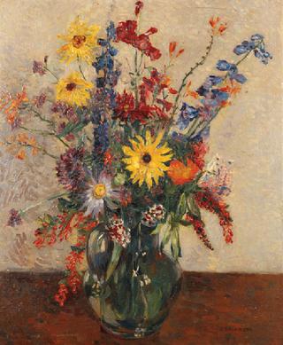 Still life of summer flowers in a glass jug on a table top