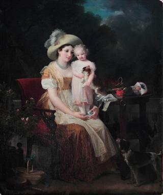Une femme assise tenant une jeune fille sur ses genoux
