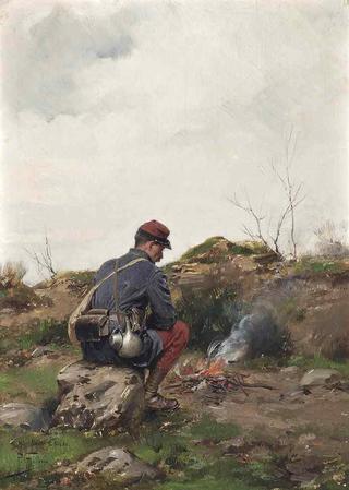 A soldier making a campfire