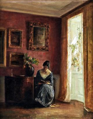 Interior with woman reading by the window