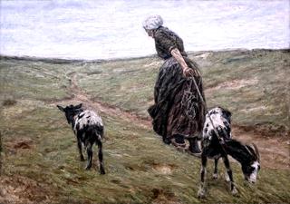沙丘上的一个女人和她的山羊
