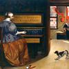 一个女人在钢琴边和一只狗