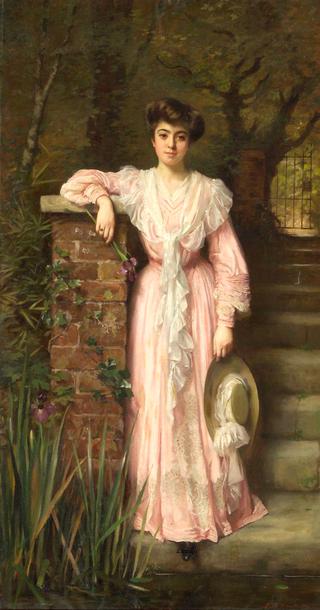 A portrait of a lady in a garden wearing a pink dress holding an iris