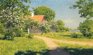 Flowering fruit trees by the red house