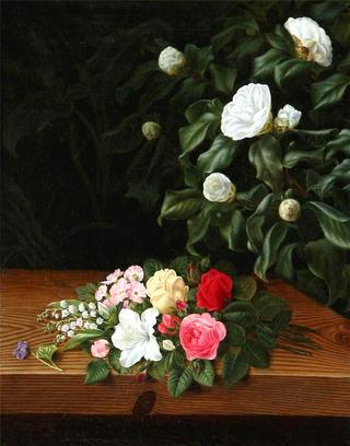 Flower bouquet on a sill at a white camillia bush and elephant ear