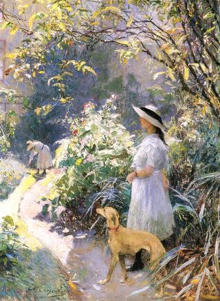 Girl with a greyhound in the garden