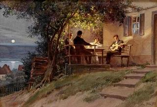 Abendliche Musik auf der Veranda des Hauses mit Gitarre spielendem Mann