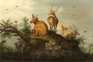 Deer and cattle on a hill in wooded landscape