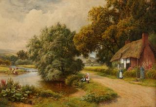 A thatched English cottage on a lake shore