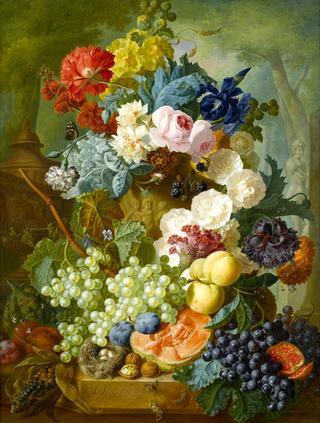 Flowers and fruit on a stone ledge in a park landscape