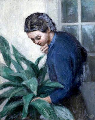 Lady in a Blue Shirt Tending a Plant