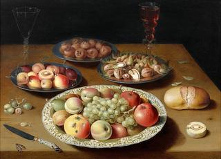 Still life with fruits, nuts, bread, two wine glasses and a knife