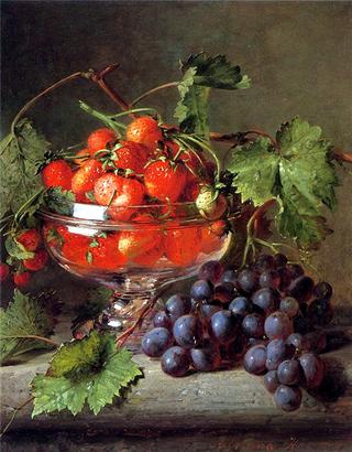 Strawberries in a glass bowl with grapes on a ledge