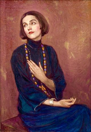 Portrait of Isadora Duncan wearing a blue dress and colored bead necklace