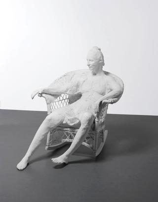 Woman in a White Wicker Rocker