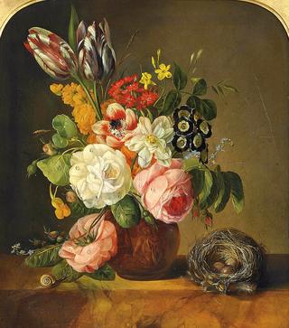 Flowers in a terracota vase with a bird's nest