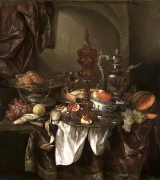 Still life with fruit, roast, silver- and glassware, porcelain and columbine cup on a dark tablecloth with white serviette.