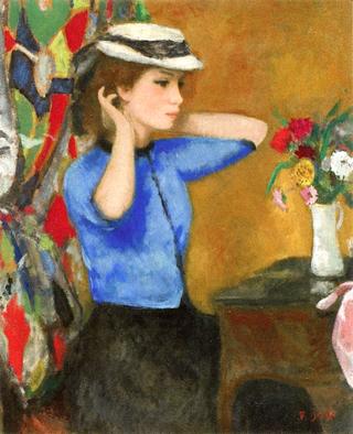 Marie-Lize Trying-on the White Hat in front of a Flowered Dresser