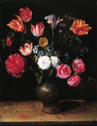 Roses, lilies, tulips, a poppy and other flowers in a stone ware jug on a ledge