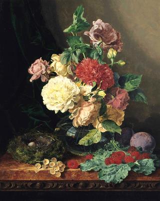 Carnations and roses in a glass vase and a birds nest