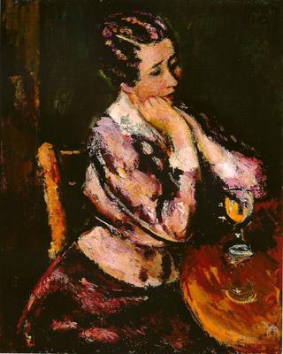 Woman with a wineglass at the table