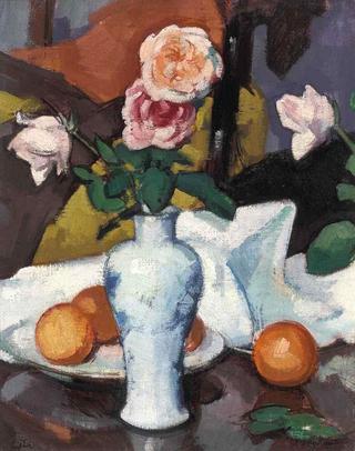 Roses in a Vase with Oranges and a White Table Cloth