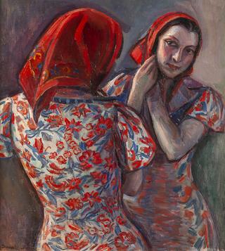 Woman with headscarf looking in a mirror