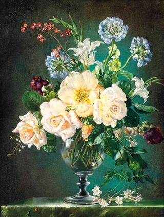 Roses, hydrangeas and other flowers in a glass vase on a marble ledge with a ladybird