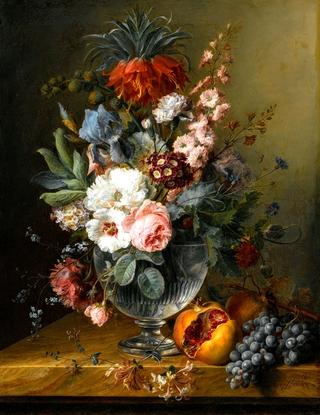 Still Life of Flowers In A Glass Vase With Honeysuckle, Pomegranates And Grapes