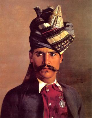 Portrait of a Khattack, buts legnth in a red waistcoat, red jacket and striped turban