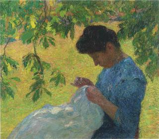 Young woman sewing in garden