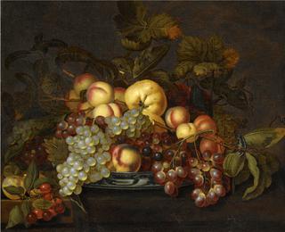 A still life with grapes, peaches and other fruit in a porcelain dish