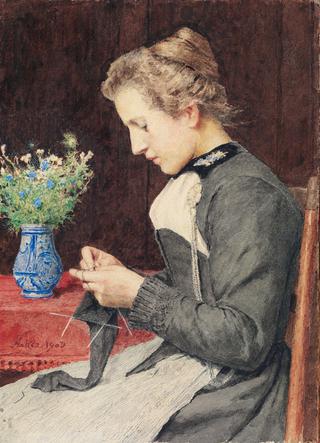 Strickende junge Frau mit Blumenstrauss