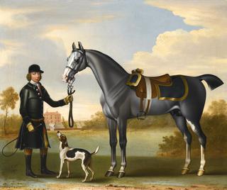 A saddled grey with a liveried groom outside a country house