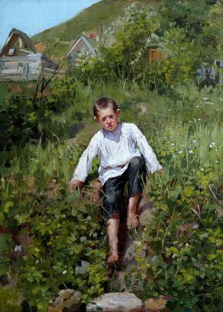 A boy climbing down a bank