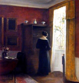 Interior with a woman by the window